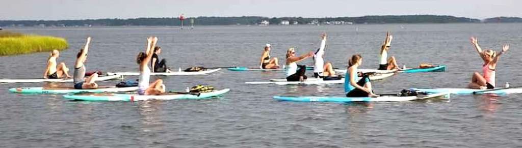 Suzy teaching paddleboard yoga